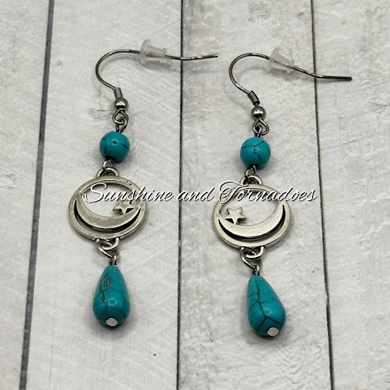 Handmade turquoise howlite gemstone earrings featuring silver-tone crescent moon and star charms with turquoise gemstone drop beads, creating elegant celestial jewellery with a bohemian style.