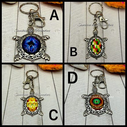 Collage of eight handmade antique silver turtle keyrings featuring colourful glass cabochons with mandala, geometric and abstract designs. Each sea turtle keychain includes a sturdy keyring and lobster clasp, making a unique handmade gift for turtle and ocean lovers.