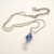 Handmade Blue Lampwork Glass Bead Pendant with Wirework Swirl | Unique Artisan Necklace UK