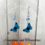 Handmade Blue Enamelled Silver Butterfly Drop Earrings with Pale Blue Faceted Glass Beads.